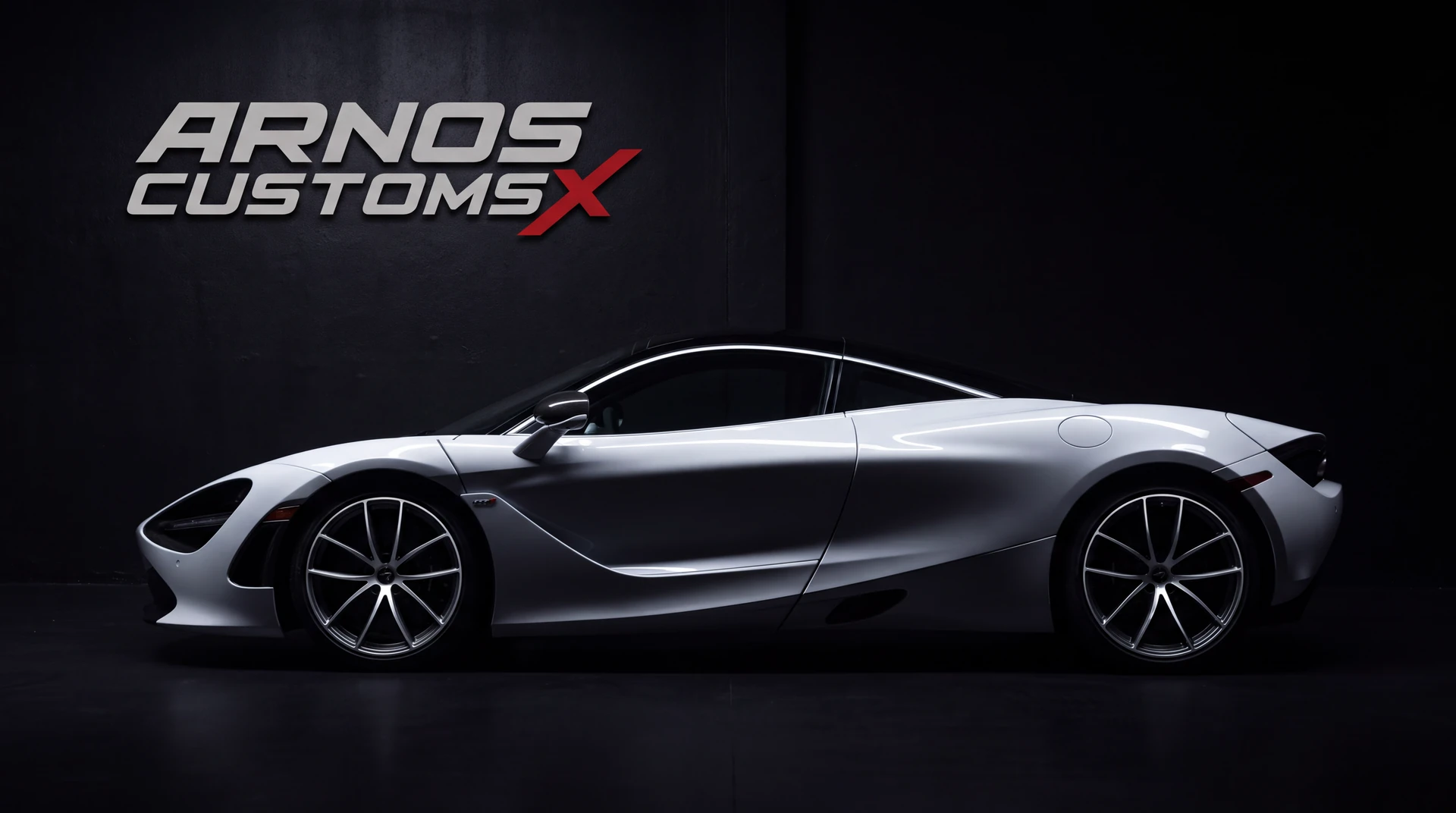 A silver supercar under the lights inside the Arnos Customzz studio in Croydon